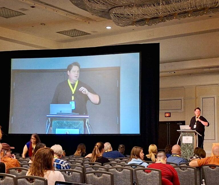 A man giving a presentation in a conference room.